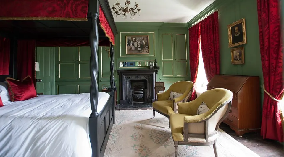 Four-poster bed and seating in the Luttrell suite at The Great House