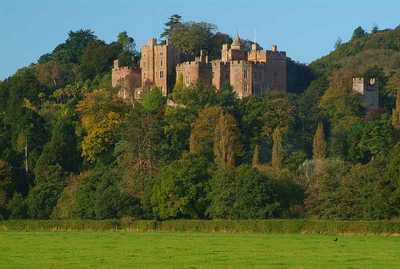 Dunster Castle above the trees on its wooded hill